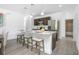 Stylish kitchen island with granite countertops, dark cabinets, and stainless steel refrigerator at 2126 7Th Ave, Deland, FL 32724