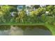 Overhead view of a home nestled in a community near a pond; framed by mature trees and lush landscaping at 522 Powers Ave, Port Orange, FL 32127