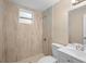 This bathroom features textured tile, a shower, a toilet and vanity sink at 522 Powers Ave, Port Orange, FL 32127
