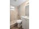 This bathroom features textured tile, a shower, a toilet and vanity sink at 522 Powers Ave, Port Orange, FL 32127