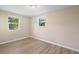 Comfortable bedroom with two windows offering natural light and wood-look flooring at 522 Powers Ave, Port Orange, FL 32127