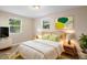 Cozy bedroom with a queen-sized bed, stylish decor, and ample natural light from two windows at 522 Powers Ave, Port Orange, FL 32127