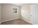 Bright bedroom with natural light from a window, neutral walls, and wood-look flooring at 522 Powers Ave, Port Orange, FL 32127