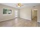 Bright bedroom featuring new wood-look flooring and a ceiling fan at 522 Powers Ave, Port Orange, FL 32127