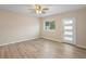 Bright bedroom featuring new wood-look flooring and a ceiling fan at 522 Powers Ave, Port Orange, FL 32127