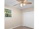 This bedroom features a ceiling fan, natural light from the window, and a closet for storage at 522 Powers Ave, Port Orange, FL 32127