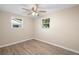 Bedroom with hardwood style flooring, two windows, and neutral paint at 522 Powers Ave, Port Orange, FL 32127