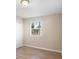 Simple bedroom featuring light wood floors, a closet, and a large window at 522 Powers Ave, Port Orange, FL 32127