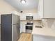 Modern kitchen with white cabinets, stainless steel appliances, and quartz countertops at 522 Powers Ave, Port Orange, FL 32127