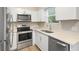 Contemporary kitchen featuring stainless steel appliances and sleek white cabinets at 522 Powers Ave, Port Orange, FL 32127