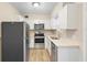 Modern kitchen with stainless steel appliances, bright lighting, and white countertops at 522 Powers Ave, Port Orange, FL 32127