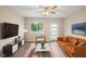 Inviting living room with neutral tones, modern furnishings, ceiling fan and bright natural light at 522 Powers Ave, Port Orange, FL 32127