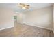Bright living room featuring light wood flooring, a ceiling fan, and neutral wall paint at 522 Powers Ave, Port Orange, FL 32127