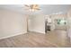 Open-concept living room and kitchen featuring new wood-look flooring and recessed lighting at 522 Powers Ave, Port Orange, FL 32127