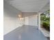 Covered back patio with painted floor and supports, with a door to the house at 522 Powers Ave, Port Orange, FL 32127