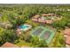 Beautiful aerial view of the community amenities, including a pool and tennis courts at 140 Orchid Woods Ct # 11A, Deltona, FL 32725