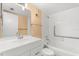 Traditional bathroom with white tiled shower/tub, matching white sink/vanity, and neutral-colored walls at 140 Orchid Woods Ct # 11A, Deltona, FL 32725