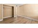 A cozy bedroom space is brightened by wood laminate flooring and natural light from the entry at 140 Orchid Woods Ct # 11A, Deltona, FL 32725