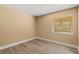 Sunny bedroom with wood-look floors and a window at 140 Orchid Woods Ct # 11A, Deltona, FL 32725