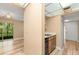 Cozy foyer leading to the kitchen and dining area, featuring wood-look floors and a sliding glass door to the outside at 140 Orchid Woods Ct # 11A, Deltona, FL 32725
