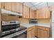 Functional kitchen with laminate cabinets, countertops, and stainless-steel range at 140 Orchid Woods Ct # 11A, Deltona, FL 32725