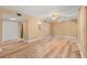 Spacious living room featuring wood-look floors, a ceiling fan, and a kitchen view at 140 Orchid Woods Ct # 11A, Deltona, FL 32725