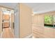 Open-concept living space with wood-look floors, adjoining kitchen, and sliding doors to a patio with wooded views at 140 Orchid Woods Ct # 11A, Deltona, FL 32725