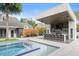 Resort-style backyard with pool, outdoor kitchen, bar seating, and luxurious landscaping at 4 Broad Creek Cir, Ormond Beach, FL 32174