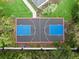 Aerial view of a backyard basketball court with blue and grey tile, and landscaping at 4 Broad Creek Cir, Ormond Beach, FL 32174
