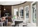 Open dining area with large windows, stylish lighting, and seamless flow to outdoor spaces at 4 Broad Creek Cir, Ormond Beach, FL 32174