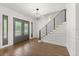 Bright foyer with wood flooring, modern light fixture, and stairs with a black metal railing at 4 Broad Creek Cir, Ormond Beach, FL 32174