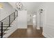 Bright foyer showcases stairs with black railing and wood flooring at 4 Broad Creek Cir, Ormond Beach, FL 32174