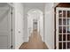 Bright hallway with archways and tile flooring provides an elegant transition between spaces at 4 Broad Creek Cir, Ormond Beach, FL 32174