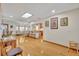 Spacious living room features wood floors, a skylight, an open layout, and views into the kitchen at 400 W Graves Ave, Orange City, FL 32763