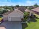 Single-story home with two-car garage and landscaped yard at 4345 Heath Land Ln, Lake Wales, FL 33859