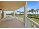 Private balcony with tiled floor and white metal railings overlooks a scenic lawn with palm trees at 4650 Links Village Dr # C303, Ponce Inlet, FL 32127