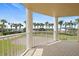 Covered balcony with views of tropical landscaping and community features beyond at 4650 Links Village Dr # C303, Ponce Inlet, FL 32127