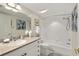 Bathroom featuring a vanity with a sink and a shower/tub with white tiles at 4650 Links Village Dr # C303, Ponce Inlet, FL 32127