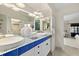 Elegant bathroom featuring double sinks, mosaic tile countertop and ensuite access to main bedroom at 4650 Links Village Dr # C303, Ponce Inlet, FL 32127