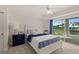 Cozy bedroom with ensuite balcony access and featuring serene views and stylish furniture at 4650 Links Village Dr # C303, Ponce Inlet, FL 32127
