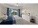 Bright bedroom featuring a large window with scenic views and neutral-toned walls at 4650 Links Village Dr # C303, Ponce Inlet, FL 32127