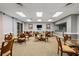 Common room featuring multiple tables and chairs with a tv on the wall at 4650 Links Village Dr # C303, Ponce Inlet, FL 32127