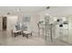 Bright dining area boasts marble floors, stylish furnishings, and open access to a modern kitchen at 4650 Links Village Dr # C303, Ponce Inlet, FL 32127