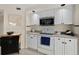 Clean kitchen featuring white cabinets, modern appliances, and neutral countertops at 4650 Links Village Dr # C303, Ponce Inlet, FL 32127