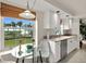 Bright kitchen with views, featuring white cabinets, stainless appliances, and a sunny breakfast area at 4650 Links Village Dr # C303, Ponce Inlet, FL 32127