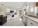 Spacious kitchen with white cabinetry, stainless steel appliances, and an adjacent breakfast nook at 4650 Links Village Dr # C303, Ponce Inlet, FL 32127