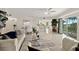 Bright living room features an open floor plan, tile floors, a kitchen, and access to a private balcony at 4650 Links Village Dr # C303, Ponce Inlet, FL 32127