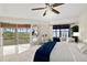Spacious main bedroom featuring tile floors, ceiling fan, ensuite bathroom and balcony with scenic views at 4650 Links Village Dr # C303, Ponce Inlet, FL 32127