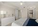Bright main bedroom featuring white furniture and easy access to ensuite bathroom and closet at 4650 Links Village Dr # C303, Ponce Inlet, FL 32127