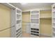 Organized walk-in closet with custom shelving, drawers and ample hanging space for optimal storage at 4650 Links Village Dr # C303, Ponce Inlet, FL 32127